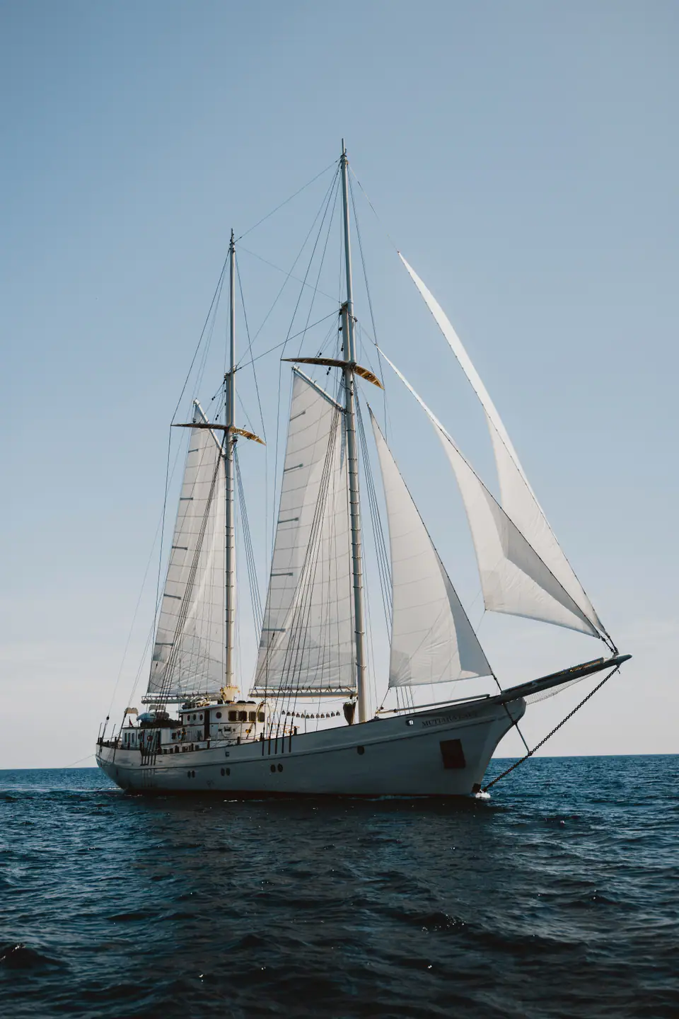 Mutiara Laut schooner sailing yacht cruising through open ocean waters.