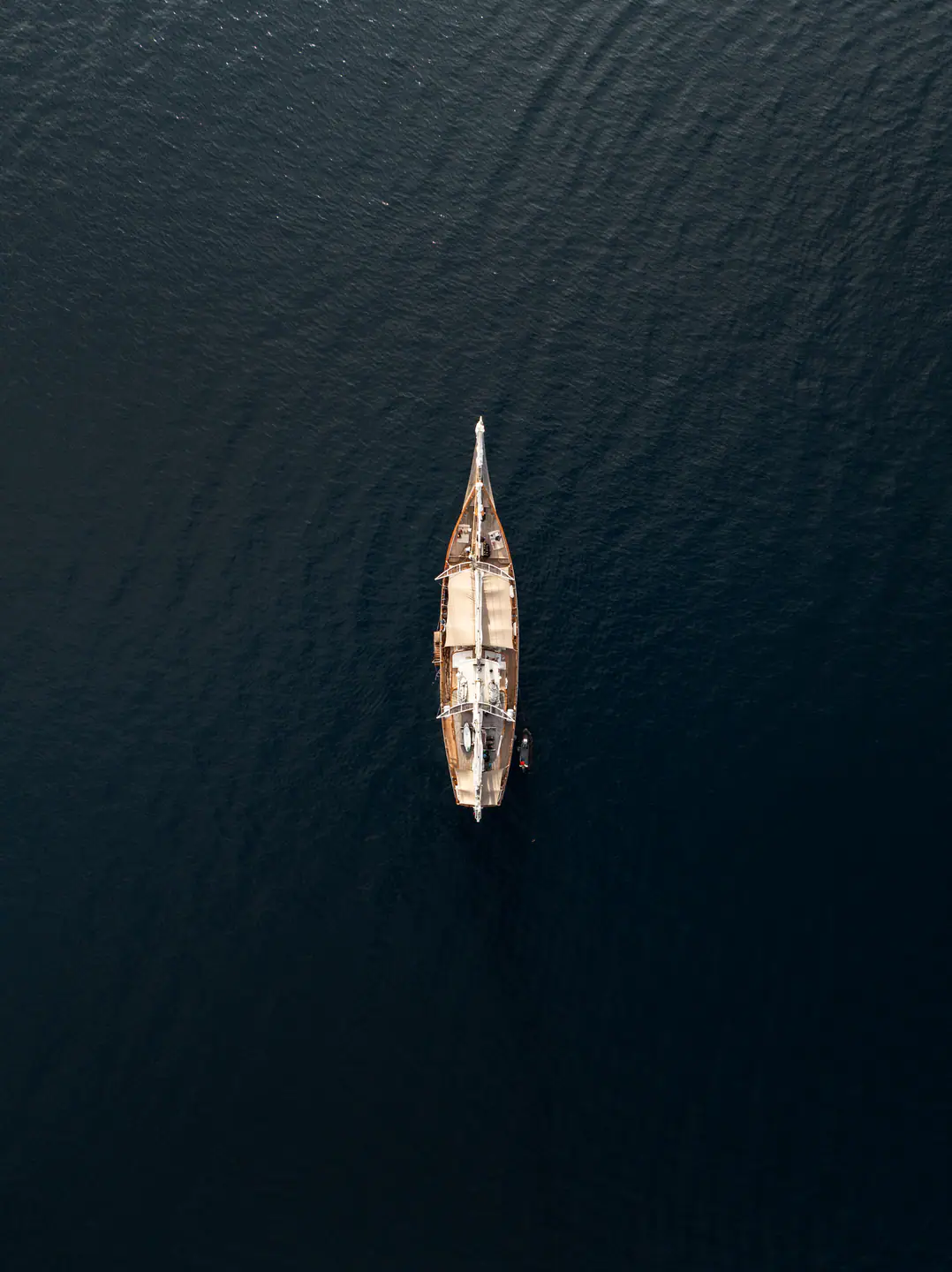 Mutiara Laut top-down aerial view of the yacht cruising through open waters.