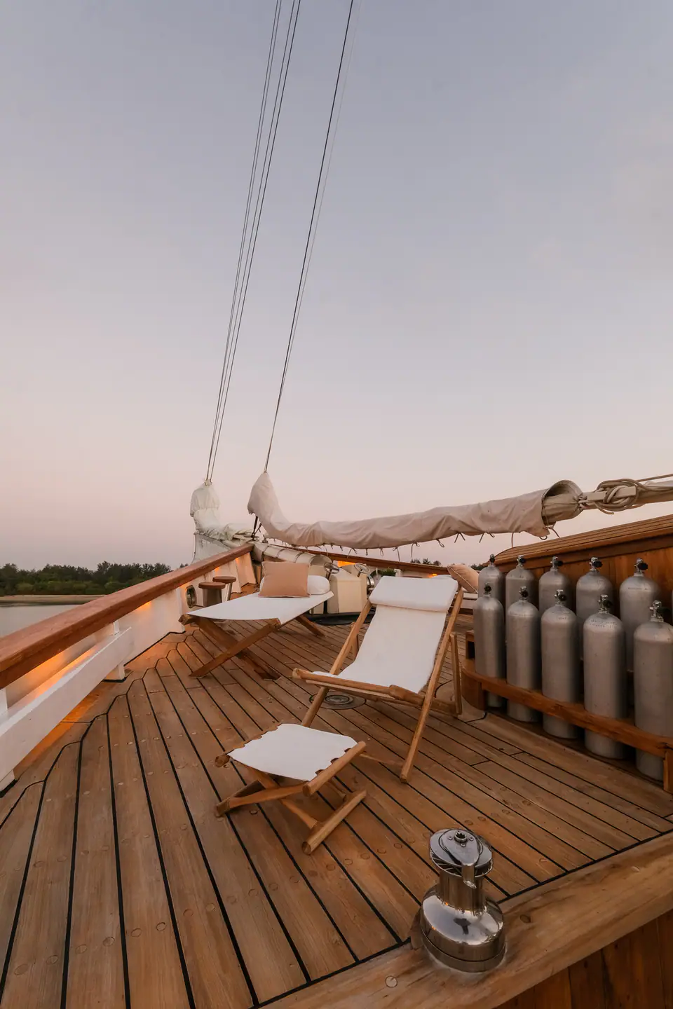 Mutiara Laut luxury phinisi yacht relaxing area on the deck layout at dawn.