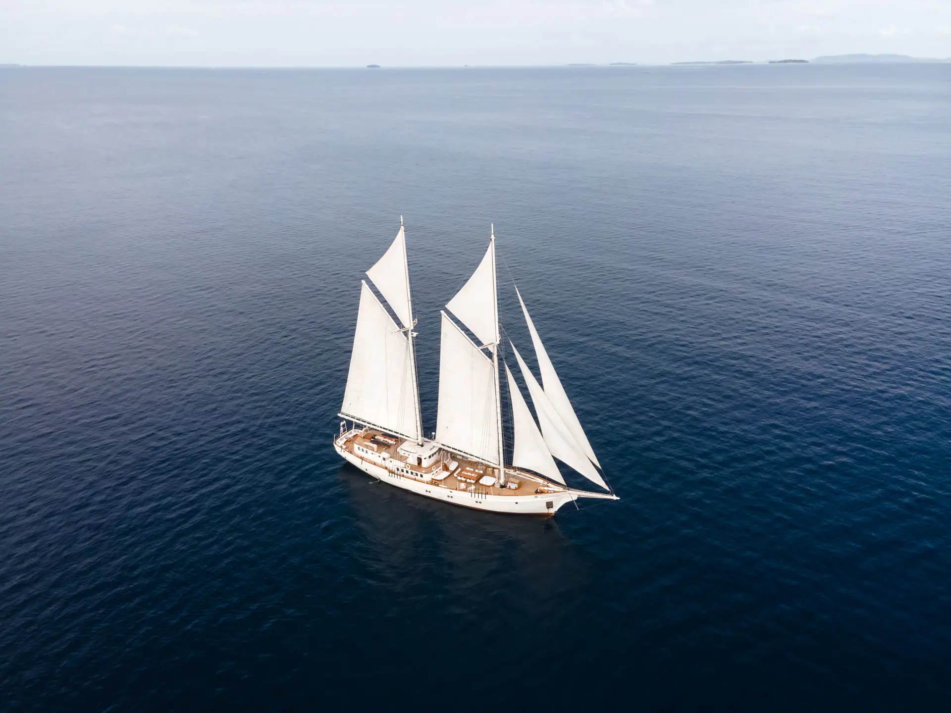 Mutiara Laut luxury phinisi yacht using its seven sails.